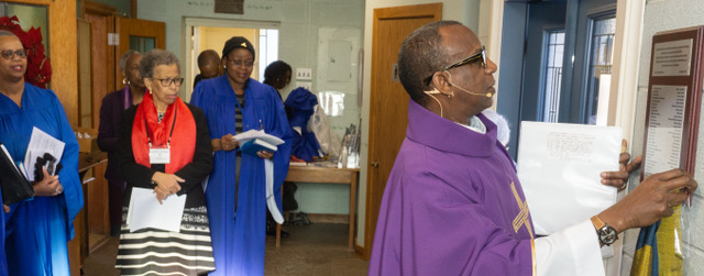 Rev'd Randy reveals the plaque listing the donors who made the purchase of our new entrance door possible.