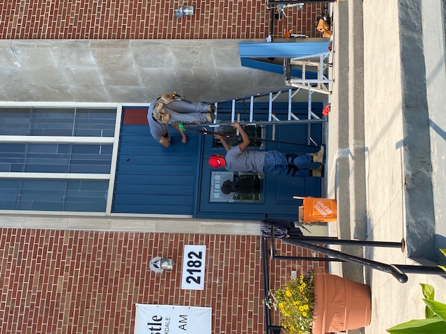 Adding finishing touches above the door.